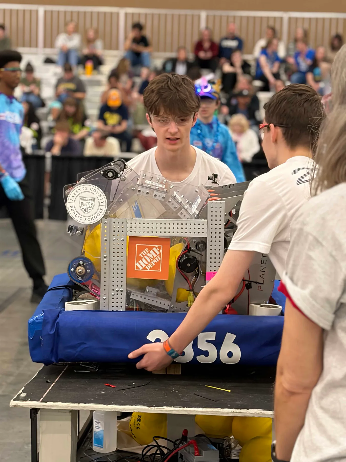 Planetary Drive students preparing robot 2856 in the competition pit