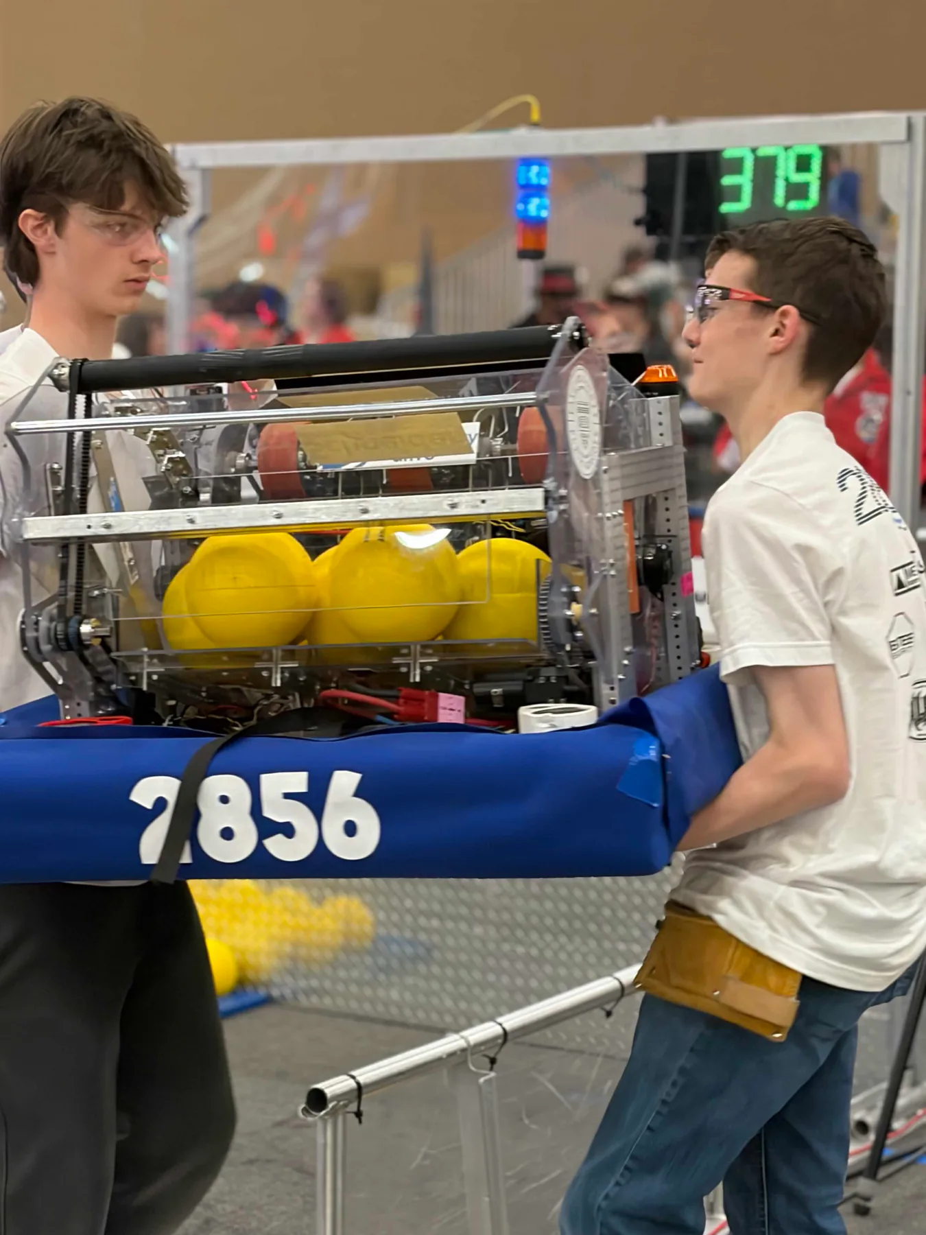 Planetary Drive students carrying their robot at competition