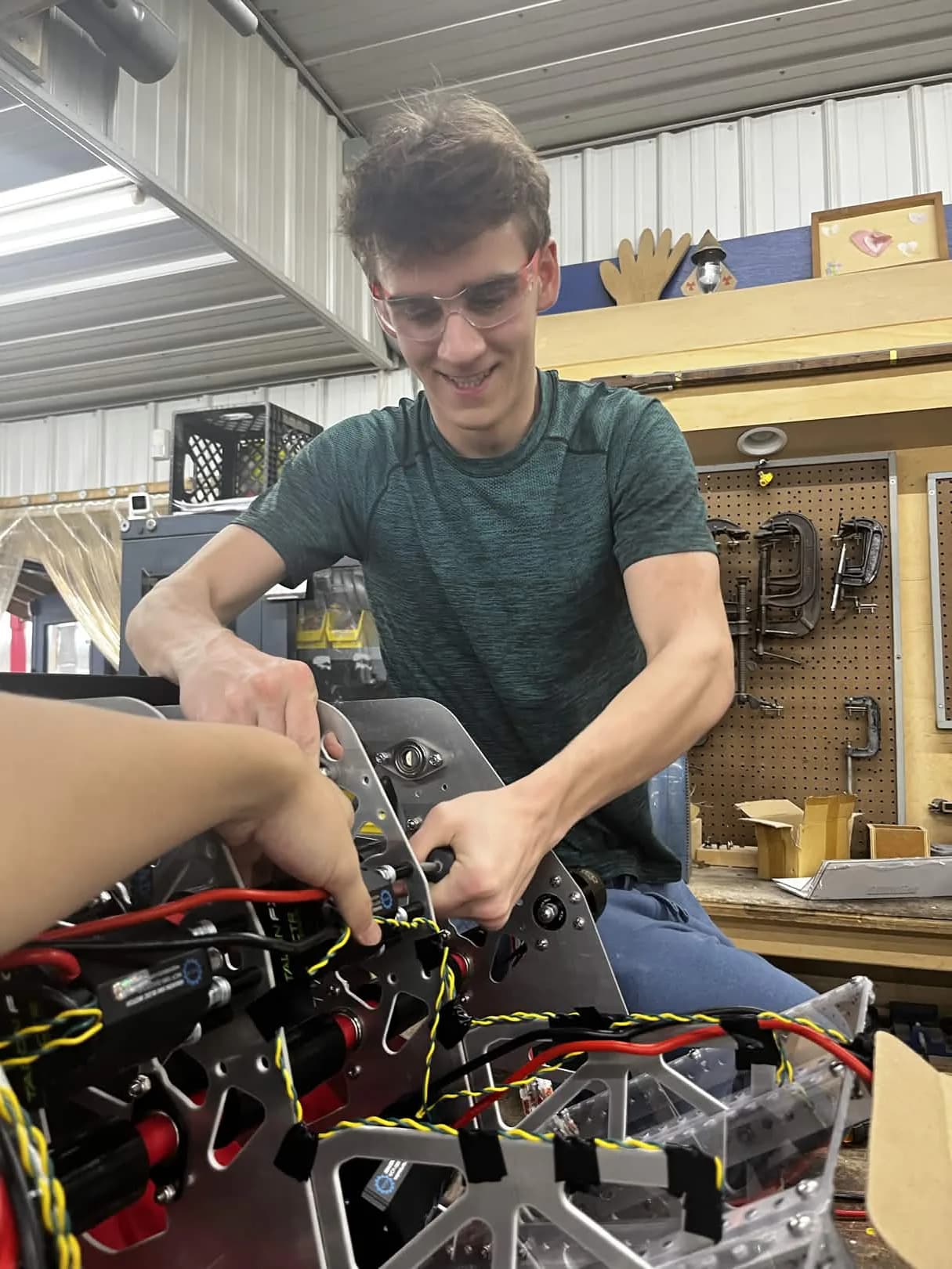 Planetary Drive student assembling a robot mechanism in the workshop