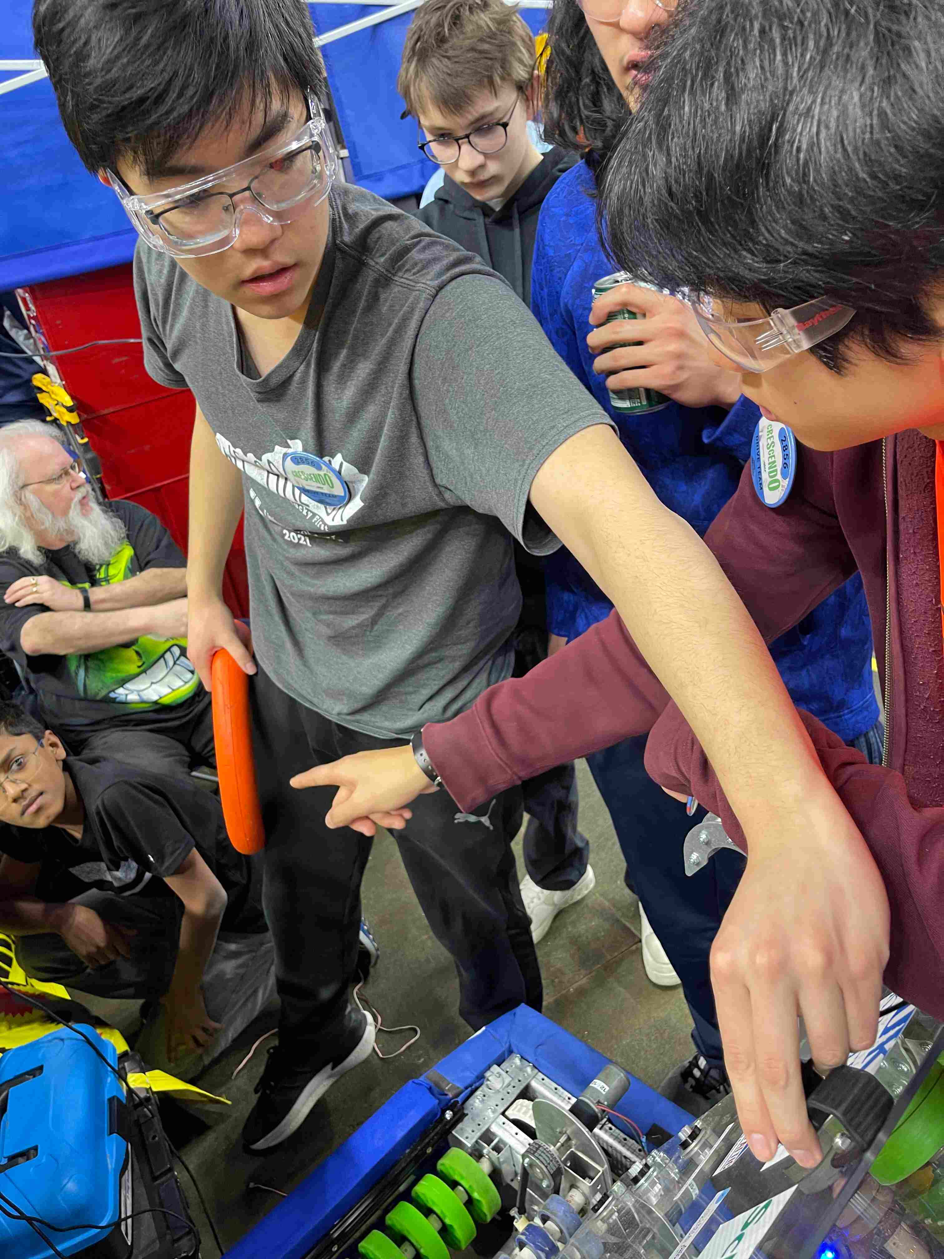 Planetary Drive students inspecting and repairing their competition robot
